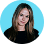 Smiling woman with long hair wearing a black top against a blue circular background.
