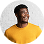 Smiling man wearing a yellow shirt against a white background.